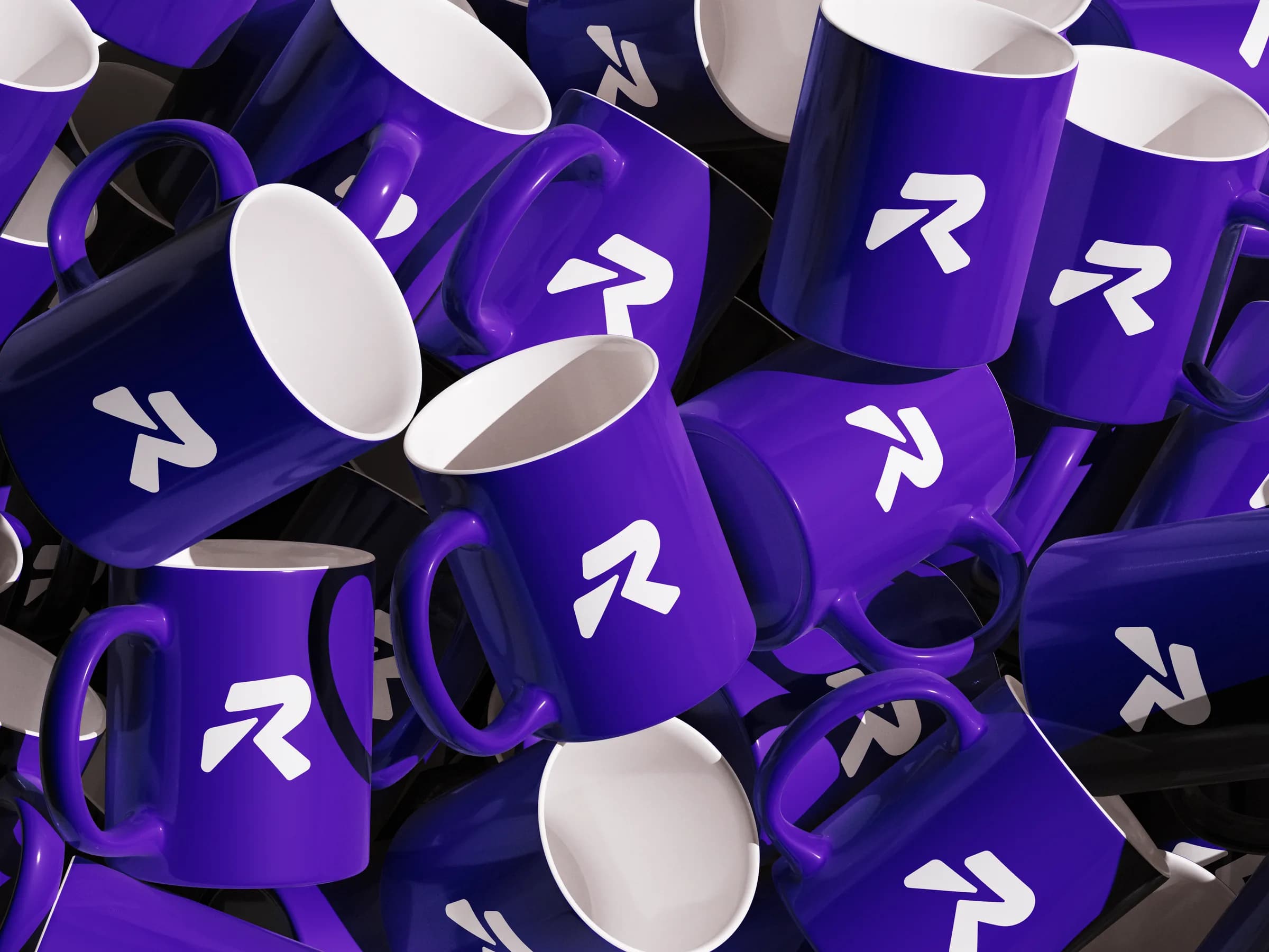 RlayHub logomark on a pile of brand mugs